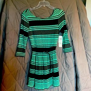 Long sleeve mini dress. Loose fit very chic and professional. Has an open back.